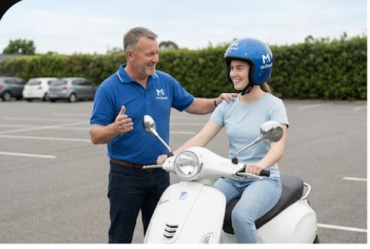 Instructor helping a student get set up on a training scooter