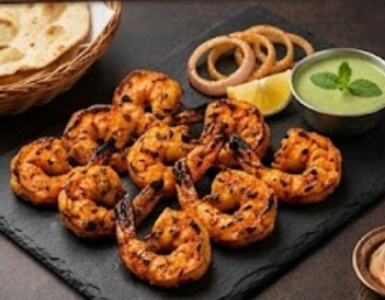 Grilled tandoori prawns with onion rings and mint chutney